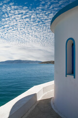 Obraz premium view of sea and sky outside of white chapel in Pachi village,Greece
