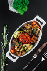 grilled vegetables on black background