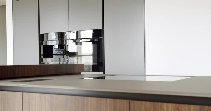 Beautiful kitchen interior with new stylish furniture. Real Luxury kitchen with an island. Modern interior in luxury house. Interior of a minimalist kitchen. Modern kitchen in minimalist apartment.