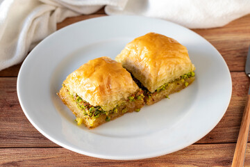 Pistachio baklava on wooden background. Traditional Turkish cuisine delicacies. close up
