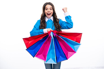 Excited face. Teenager hold shopping bag enjoying sale. Child girl is ready to go shopping. Amazed expression, cheerful and glad.