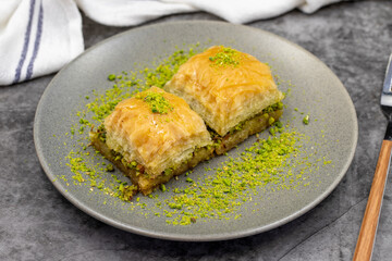 Pistachio baklava on dark background. Traditional Turkish cuisine delicacies. close up