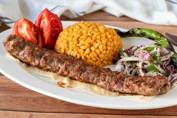 Adana kebab on wood background. Traditional Turkish kebab delicacies. close up