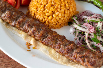 Adana kebab on wood background. Traditional Turkish kebab delicacies. close up