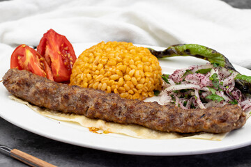 Adana kebab on dark background. Traditional Turkish kebab delicacies. close up