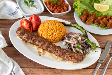 Adana kebab on wood background. Traditional Turkish kebab delicacies. close up