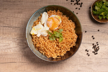 Instant noodles with boiled eggs. On wooden floor.