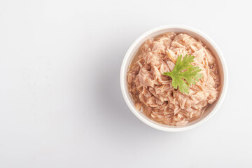 canned tuna in a white cup on a white background