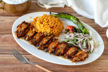 Grilled chicken wing skewers on wood background. Turkish foods. close up