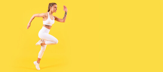 Fototapeta na wymiar fitness girl jumping in sportswear on yellow background. Woman jumping running banner with mock up copyspace.