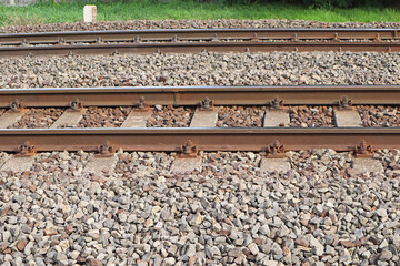 Naklejka premium Railroad and stones with rusty iron railway
