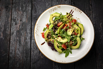 delicious salad in a plate on a dark table
