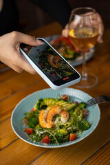tasty salad in a plate on a brown table

