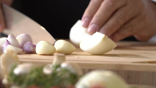 Cut mixed Onion, red Onion and Galic into small pieces and slice with a kitchen knife by professional chef.
