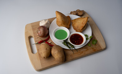Veg Samosa - is a crispy and spicy Indian triangle shape snack which has crisp outer layer of maida filling of mashed potato, peas and spices