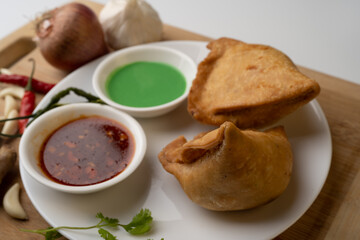 Veg Samosa - is a crispy and spicy Indian triangle shape snack which has crisp outer layer of maida filling of mashed potato, peas and spices