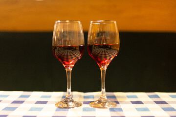two glasses of red wine on the table