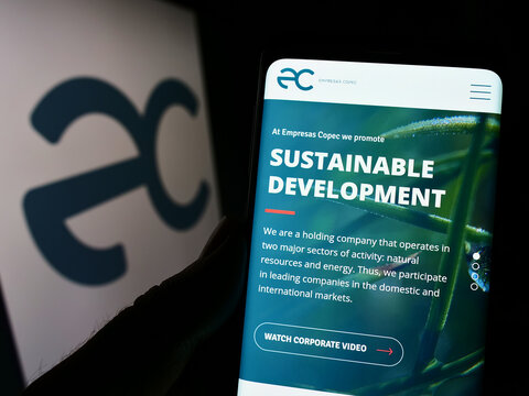 Stuttgart, Germany - 10-01-2022: Person holding smartphone with webpage of Chilean company Empresas Copec S.A. on screen in front of logo. Focus on center of phone display.