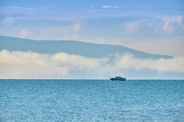 Kurbulik, Republic of Buryatia, Russia - July 11, 2022: A ship with tourists in the Chivyrkuysky Bay of Lake Baikal.