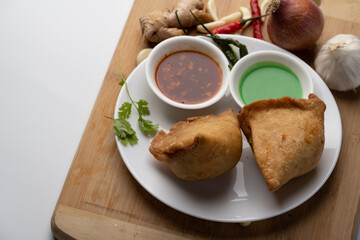 Veg Samosa - is a crispy and spicy Indian triangle shape snack which has crisp outer layer of maida filling of mashed potato, peas and spices