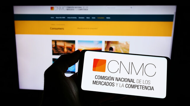 Stuttgart, Germany - 10-01-2022: Person Holding Cellphone With Logo Of Spanish Competition Regulator CNMC On Screen In Front Of Webpage. Focus On Phone Display.