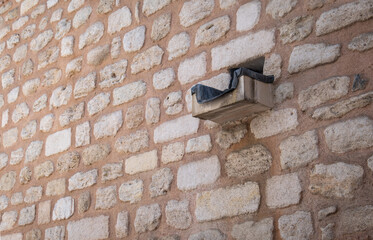 rain gutter on stone wall of historic building