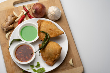 Veg Samosa - is a crispy and spicy Indian triangle shape snack which has crisp outer layer of maida filling of mashed potato, peas and spices