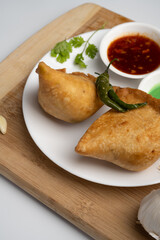 Veg Samosa - is a crispy and spicy Indian triangle shape snack which has crisp outer layer of maida filling of mashed potato, peas and spices
