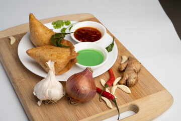 Veg Samosa - is a crispy and spicy Indian triangle shape snack which has crisp outer layer of maida filling of mashed potato, peas and spices