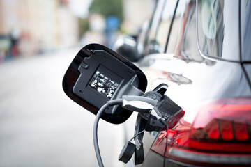 Electric car plugged to a charging station