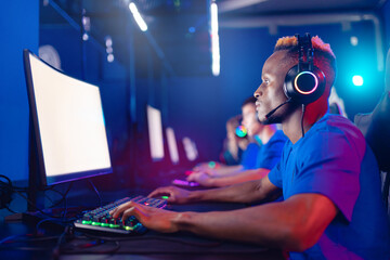 Portrait african young man in headphones. Team professional gamer playing winning tournaments online games computer, white screen, soft focus
