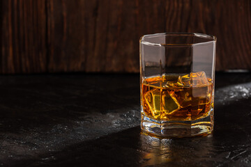 Whiskey with Ice on a Wooden Table