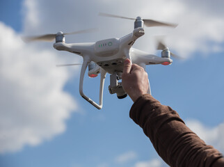 Drone holds a male hand before flying