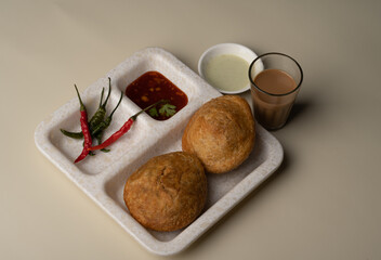 Kachori and samosa, Indian vegetarian snacks served with green and tamarind chutneys.