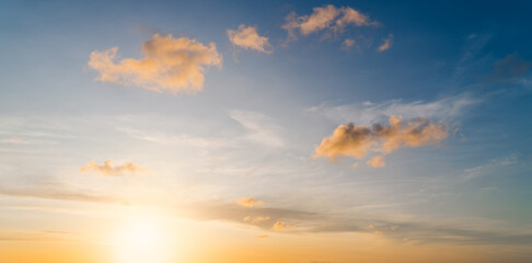 Fototapeta premium Sunset sky clouds in the morning sunrise with golden sunshine and orange, yellow on blue sky background 