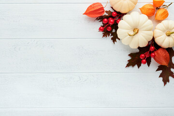 Halloween festive autumn background. Autumn decor from pumpkins, berries, maple leaves and...