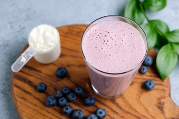Blueberry protein smoothie in glass, healthy vegan sport drink