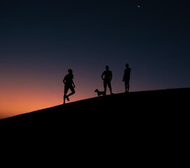 silhouettes on a hill