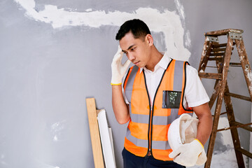 A construction worker scratches head in despair on home renovation project