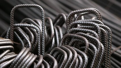 A stack of concrete rebar links. Steel rods in shape - Powered by Adobe
