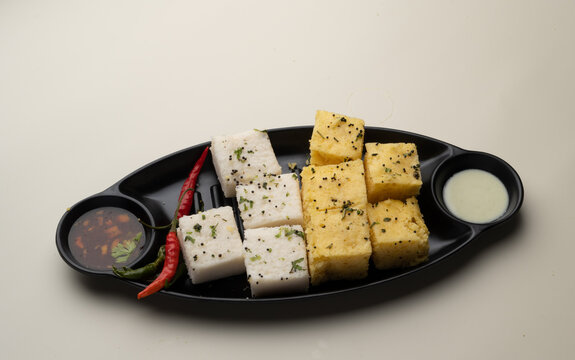 Indian popular Gujrati breakfast dish White Dhokla, Khatta , Rice and Urad Dal Khaman. Also known as Instant Rava Dhokla AND yellow dhokla or besan gram flour. served with ketchup 