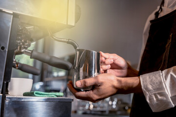 Fototapeta na wymiar Close up coffee Barista hands working with coffee making machine in coffee shop, Coffee Barista Concept