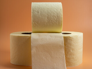 Roll of Toilet paper on an orange background.