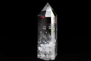 Real clear crystal quartz point focused macro isolated on black surface 