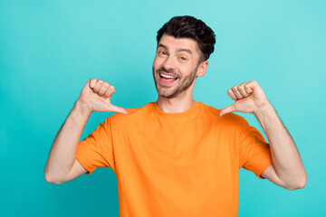 Closeup photo of young funny excited positive toothy smile man wear orange t-shirt showing fingers...