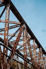 Fototapeta na wymiar old metal bridge with blue sky in the background