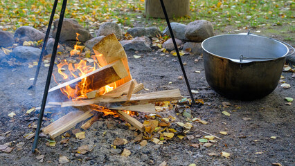 Cooking in a pot on an open fire in nature. Bowler on a bonfire in the forest.