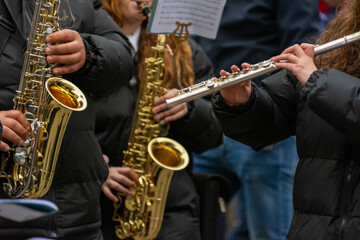 Musicians From A Popular Band Playing Traverse Flute and Saxophones During A Religious Procession