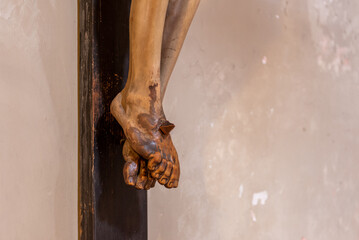 Close Up of the Feet of Wooden Crucifix In The Basilic of Saint Clemens in Rome, Soiled by the...