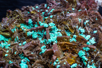 Real brown albite crystal cluster with small light green malachite clusters isolated on black. Macro